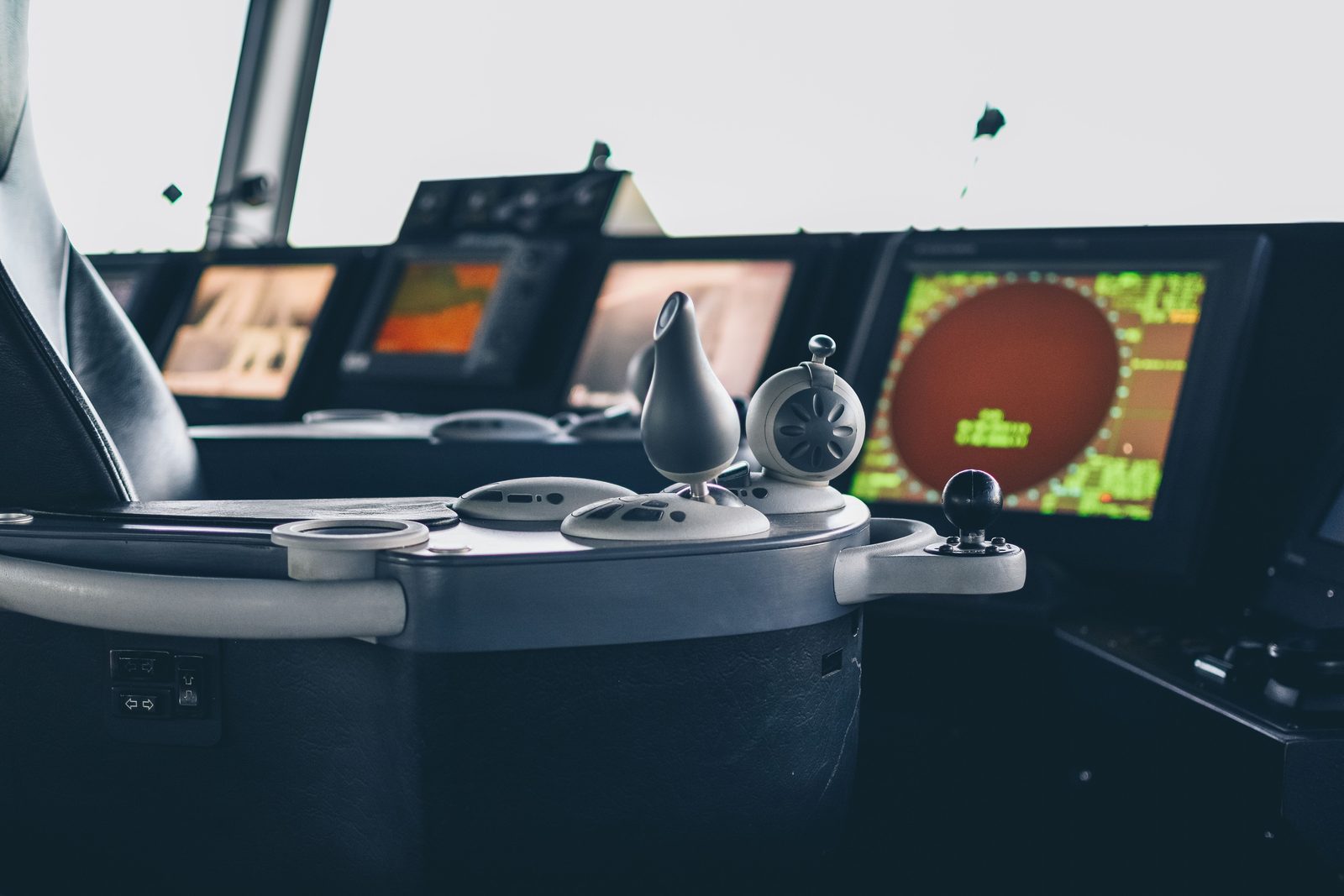 A yacht's radar screens and helm controls